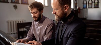 close-up-priest-talking-with-person (1)